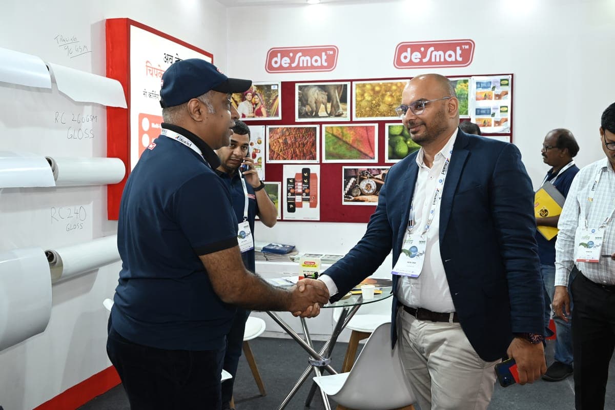 A Desmat team member shaking hands with a visitor at the Desmat exhibition stall