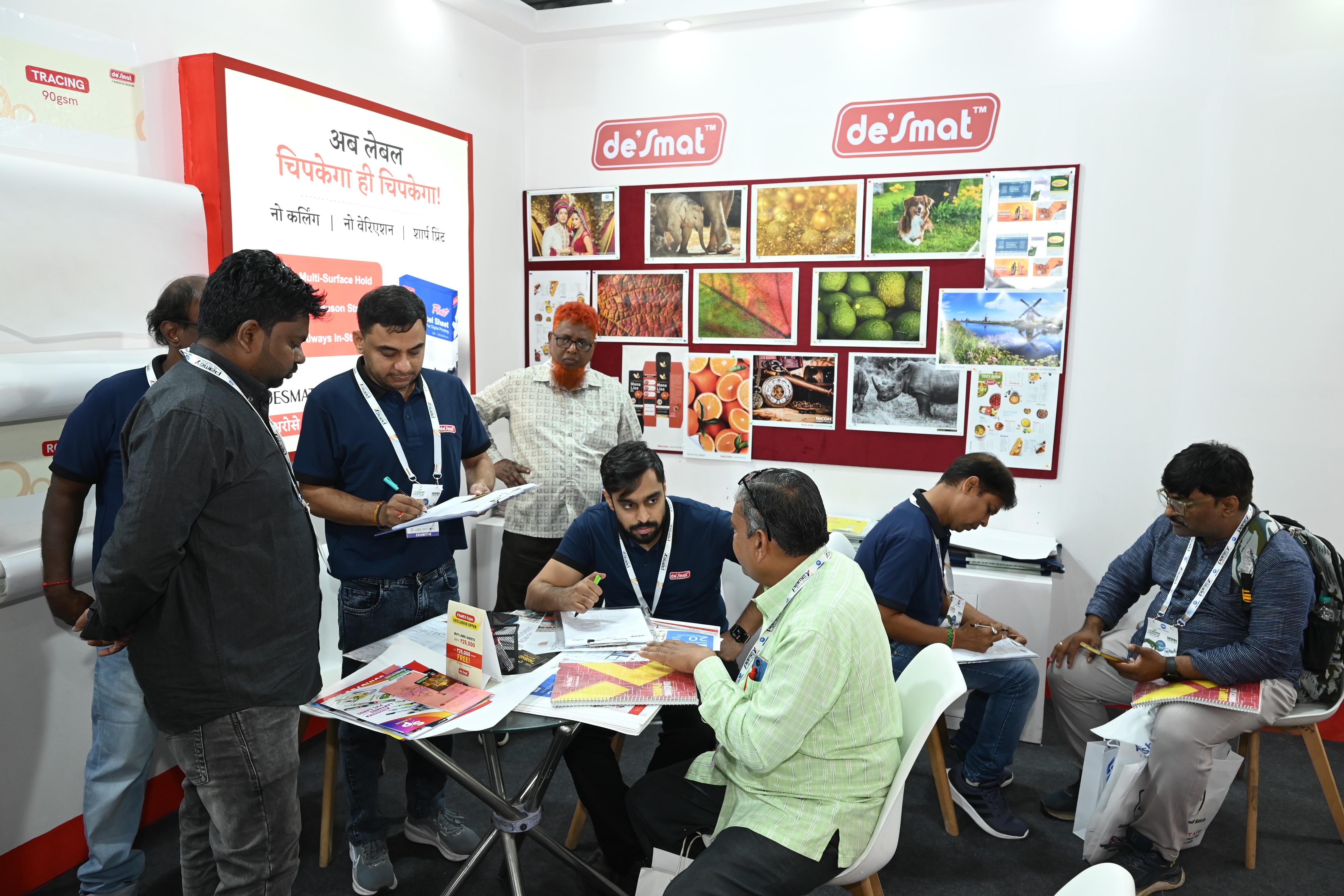 Visitors looking through Desmat product catalogues with the Desmat team