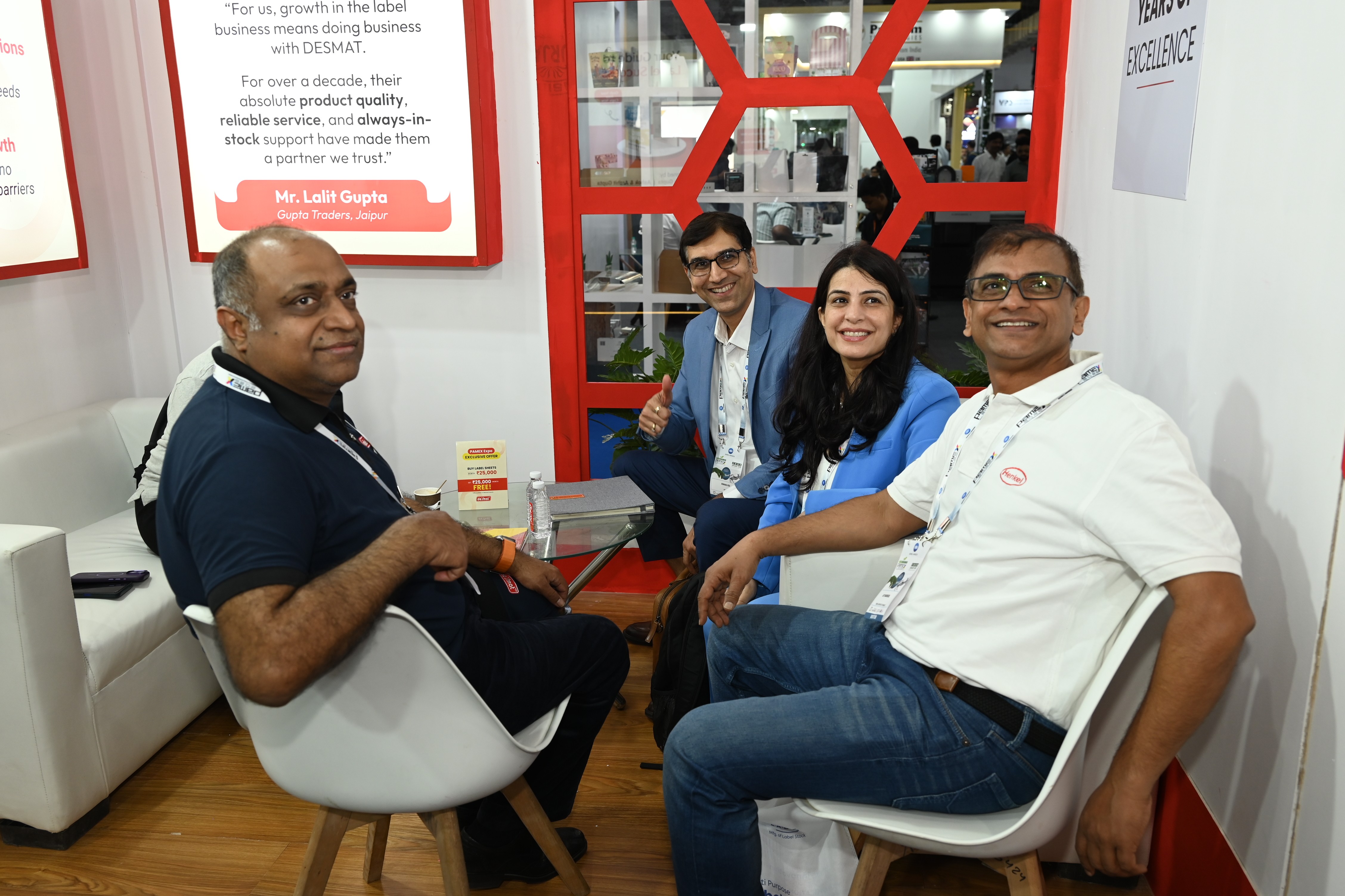 Visitors seated with the Desmat team at the Desmat exhibition stall