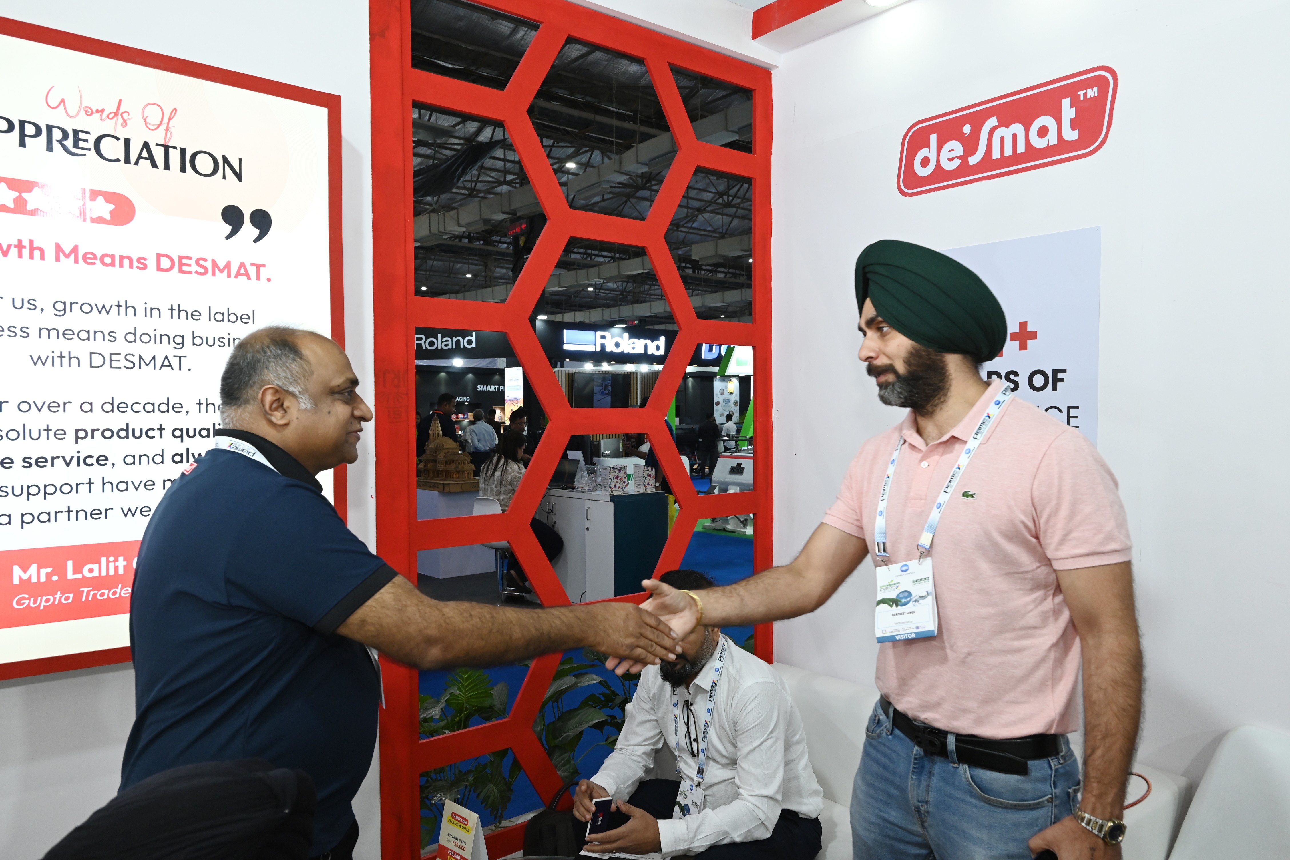 A Desmat team member greeting a visitor at the Desmat stall